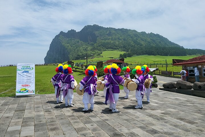 Experience the unique culture of Jeju Island with traditional performances set against stunning natural backdrops creating unforgettable memories as you explore its rich heritage and breathtaking landscapes.
